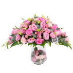 Mix pink flowers in a glass vase.
