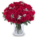 Red roses in a glass vase.