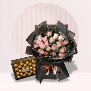 f a bouquet of pink roses and a box of Ferrero Rocher chocolates, set against a light pink background with a white circle behind it. The bouquet is wrapped in dark gray paper with a brown ribbon tied around it