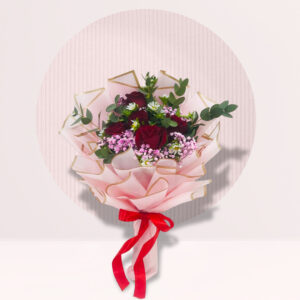 bouquet of flowers, wrapped in pink paper and tied with a red ribbon, against a light pink background with a white circle behind it. The bouquet contains red roses, white daisies, and sprigs of green leaves. The overall aesthetic is soft and romantic